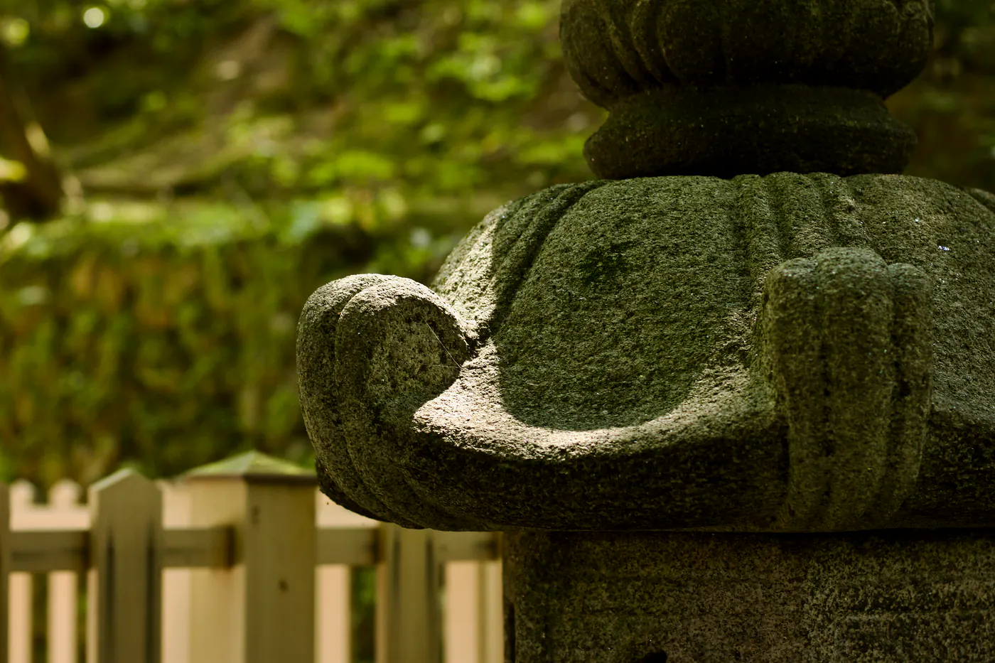 a moss-covered stone lantern, in a temple nearby