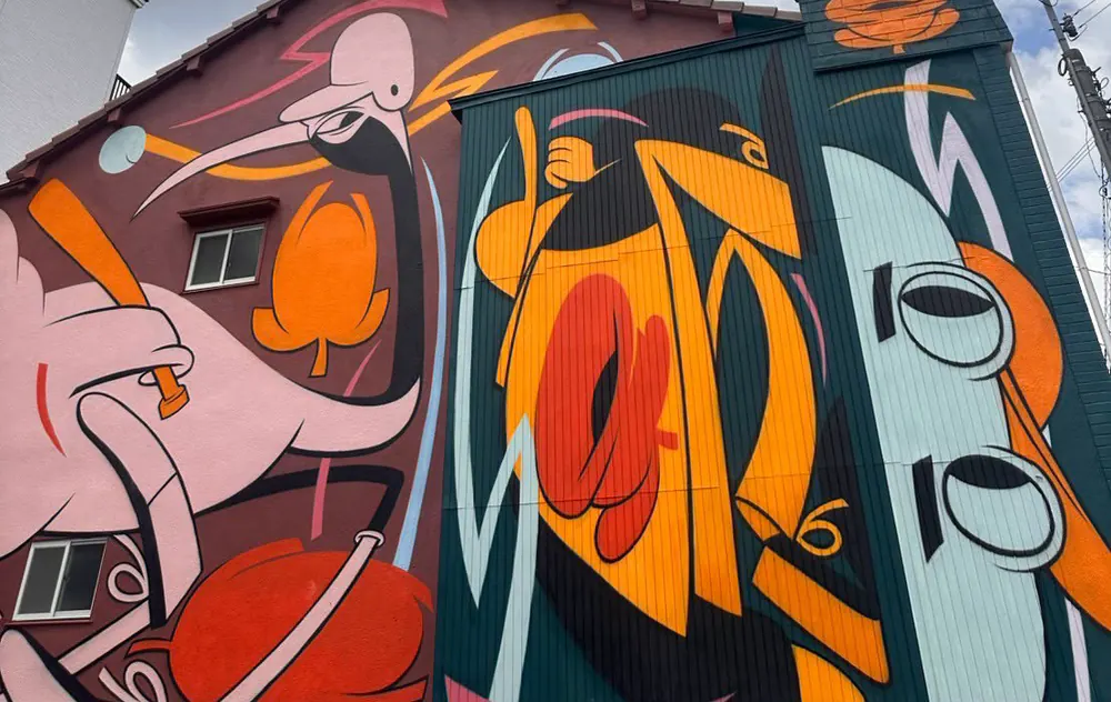orange and turquoise shapes across two neighbouring houses